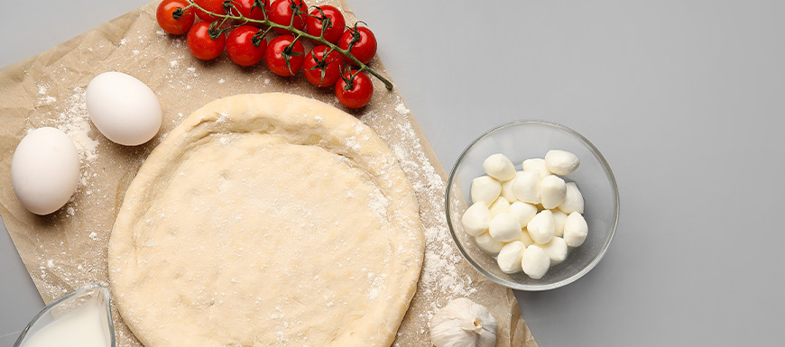 raw pizza dough eggs and tomatoes 